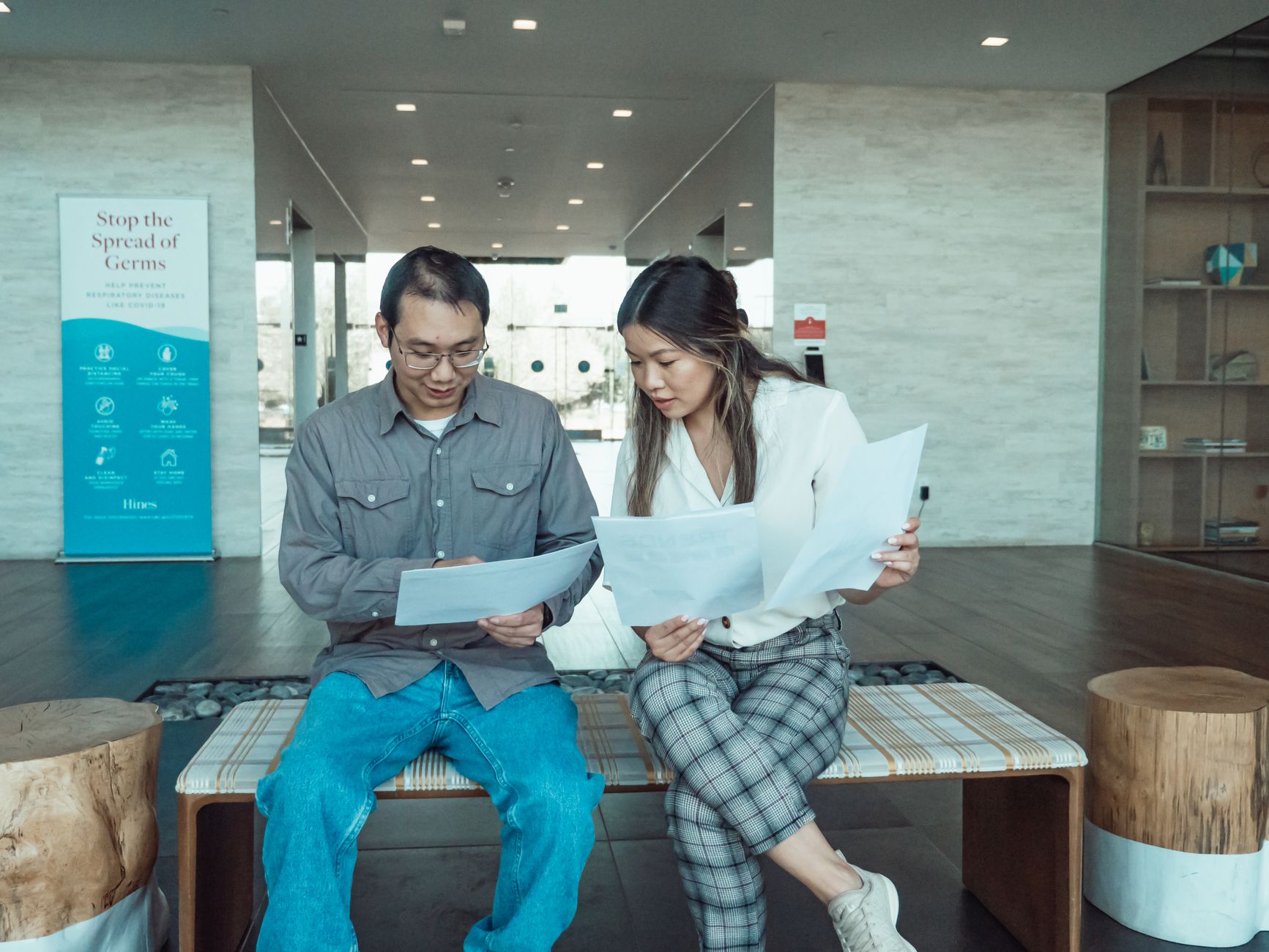 A student reviewing notes and a resume while preparing for an interview